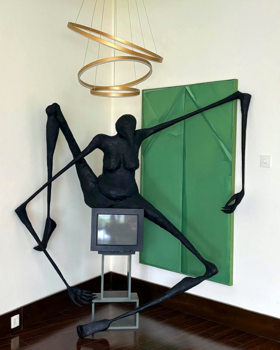 A sculpture beneath a circular halo pendant